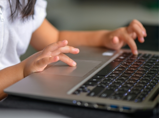 Student typing on computer